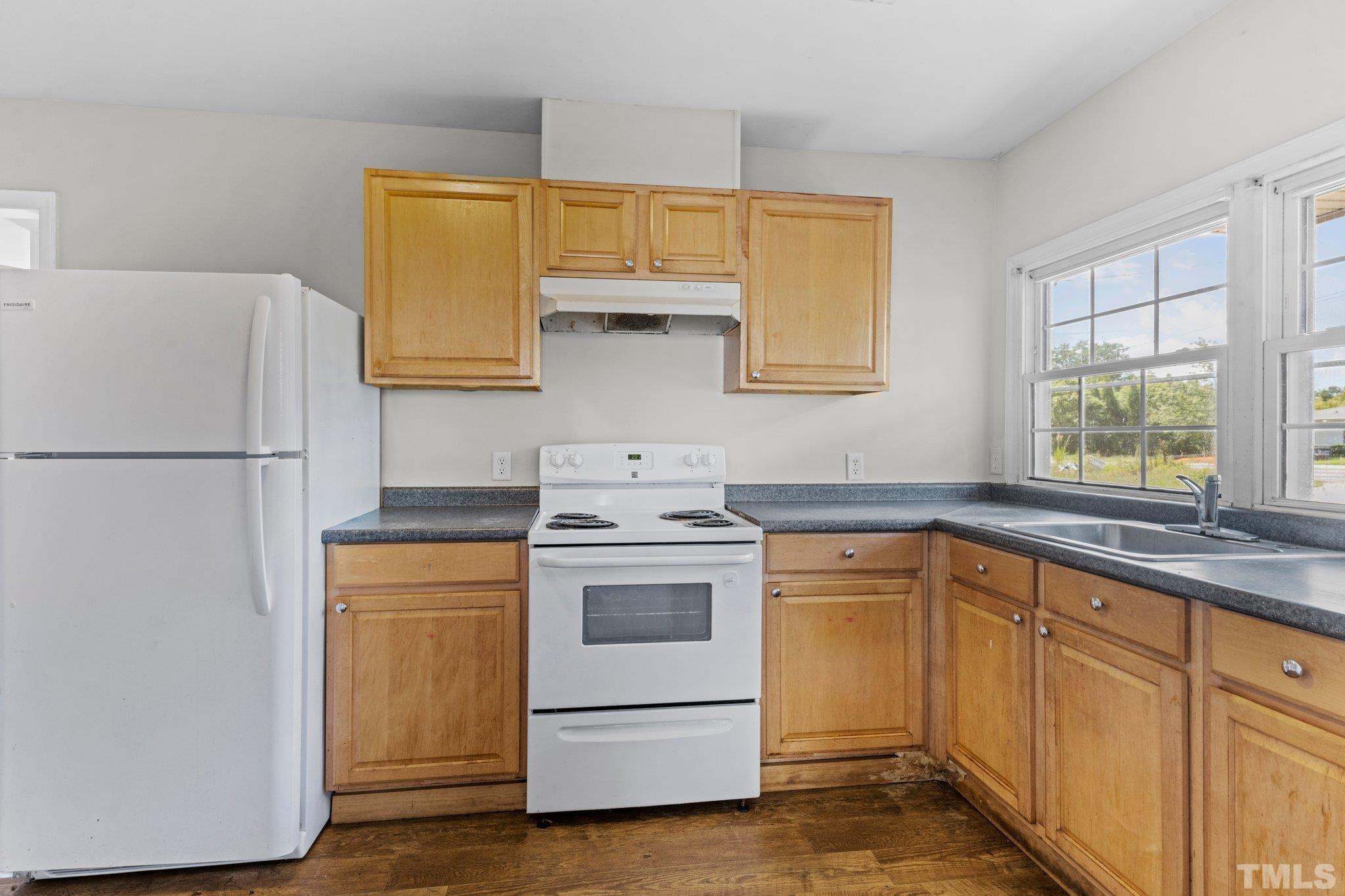 405 Jones Franklin Road Raleigh, NC 27606 - Photo 13 of 41 a kitchen with a stove sink and refrigerator