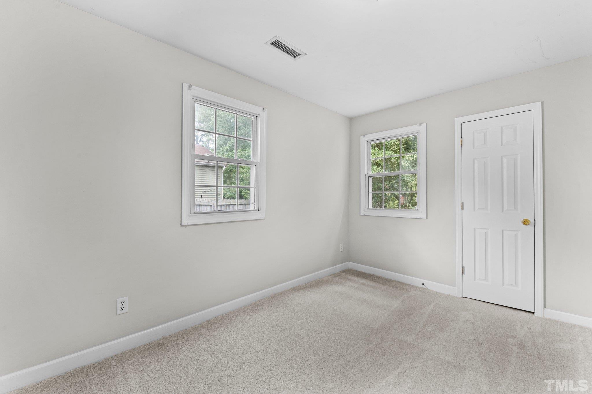 405 Jones Franklin Road Raleigh, NC 27606 - Photo 15 of 41 an empty room with windows