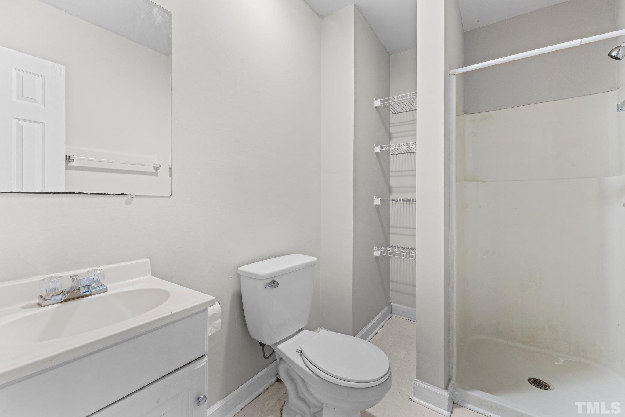 405 Jones Franklin Road Raleigh, NC 27606 - Photo 19 of 41 a white toilet sitting next to a bathroom sink
