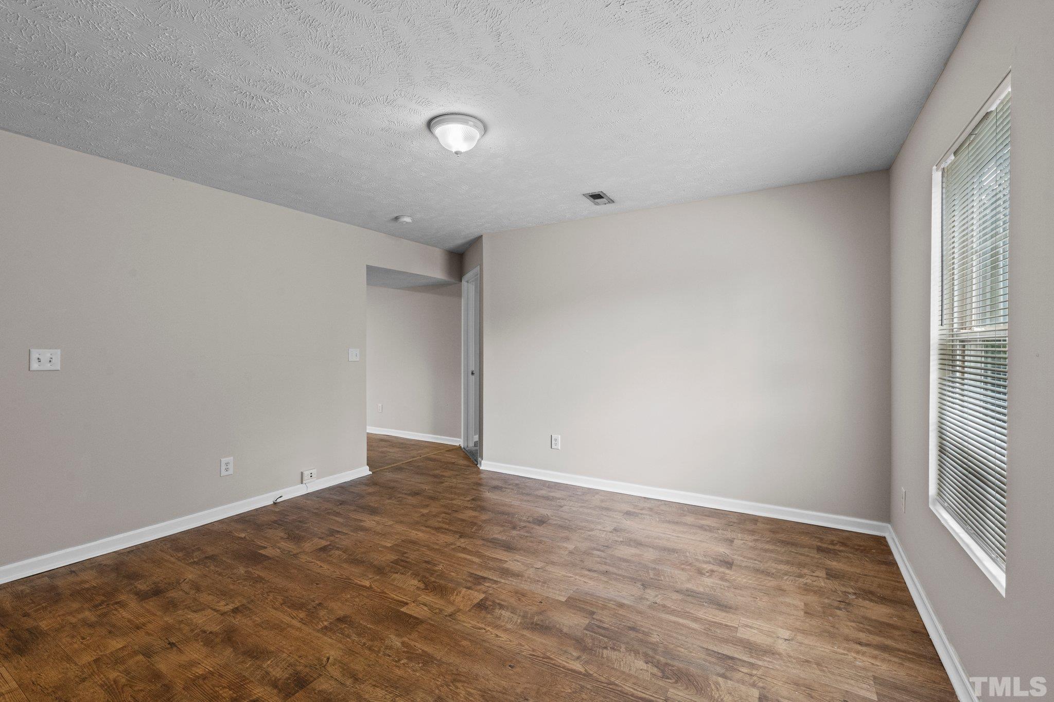 405 Jones Franklin Road Raleigh, NC 27606 - Photo 22 of 41 wooden floor in an empty room with a window