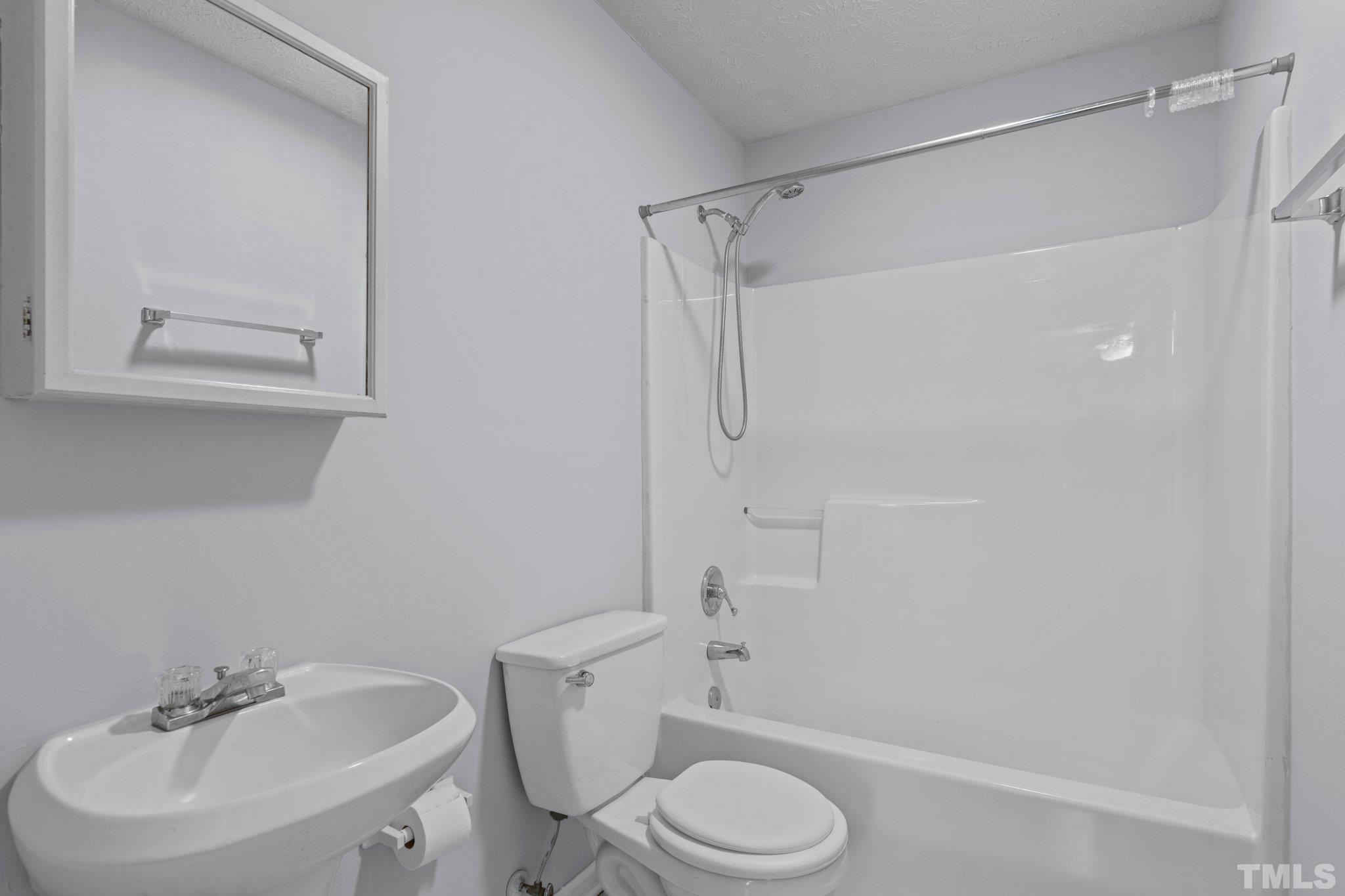 405 Jones Franklin Road Raleigh, NC 27606 - Photo 25 of 41 a white toilet sitting next to a bathroom sink