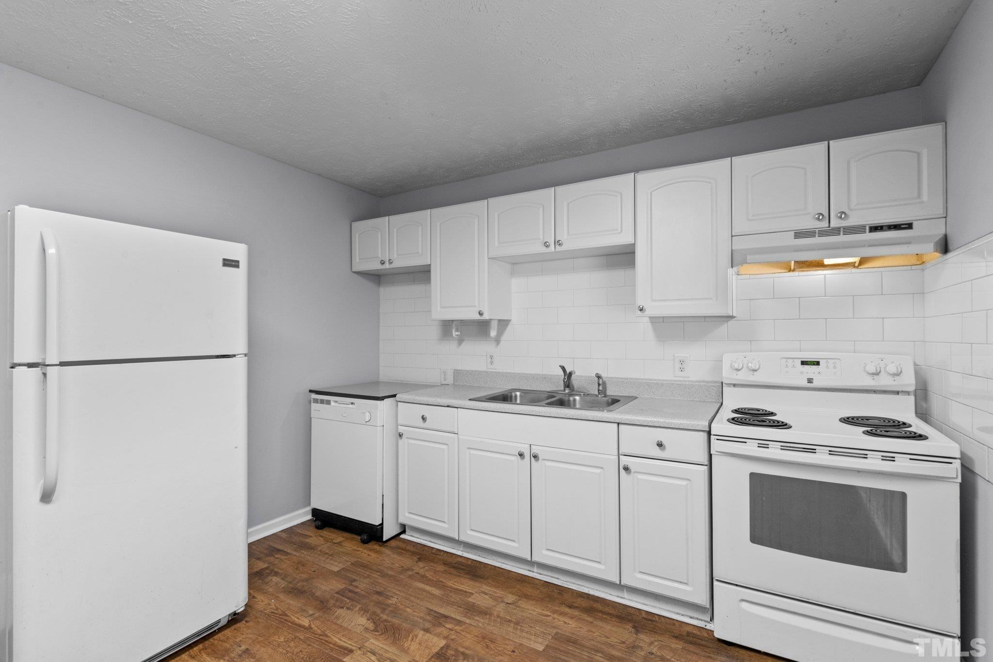 405 Jones Franklin Road Raleigh, NC 27606 - Photo 29 of 41 a kitchen with stainless steel appliances granite countertop a sink stove and refrigerator