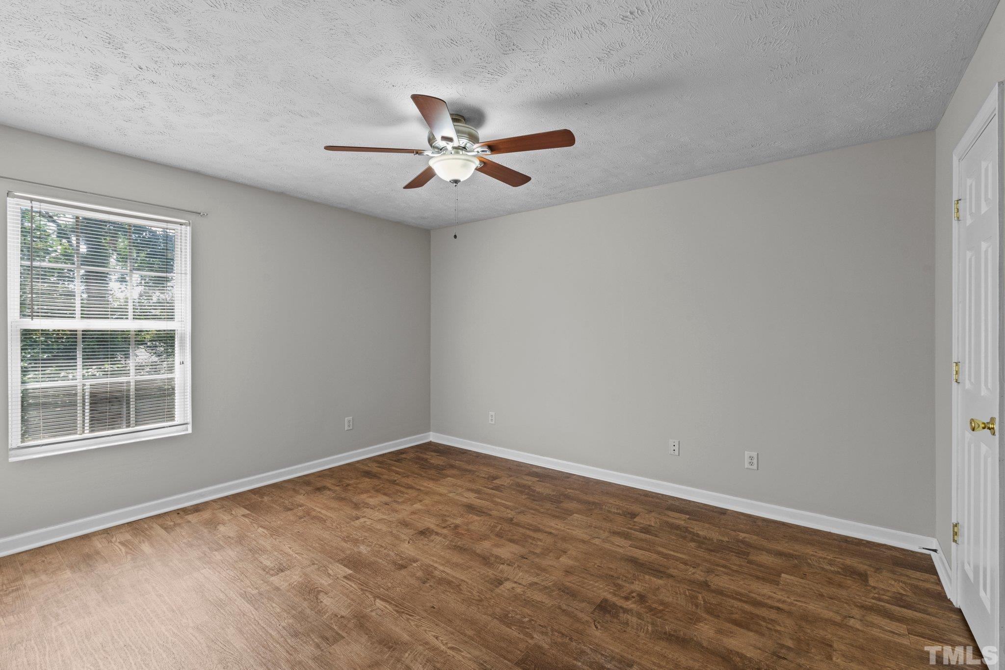 405 Jones Franklin Road Raleigh, NC 27606 - Photo 32 of 41 an empty room with a window and ceiling fan