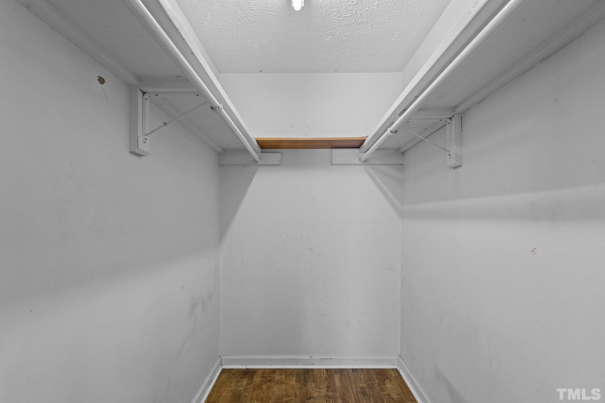405 Jones Franklin Road Raleigh, NC 27606 - Photo 36 of 41 a view of walk in closet with empty racks