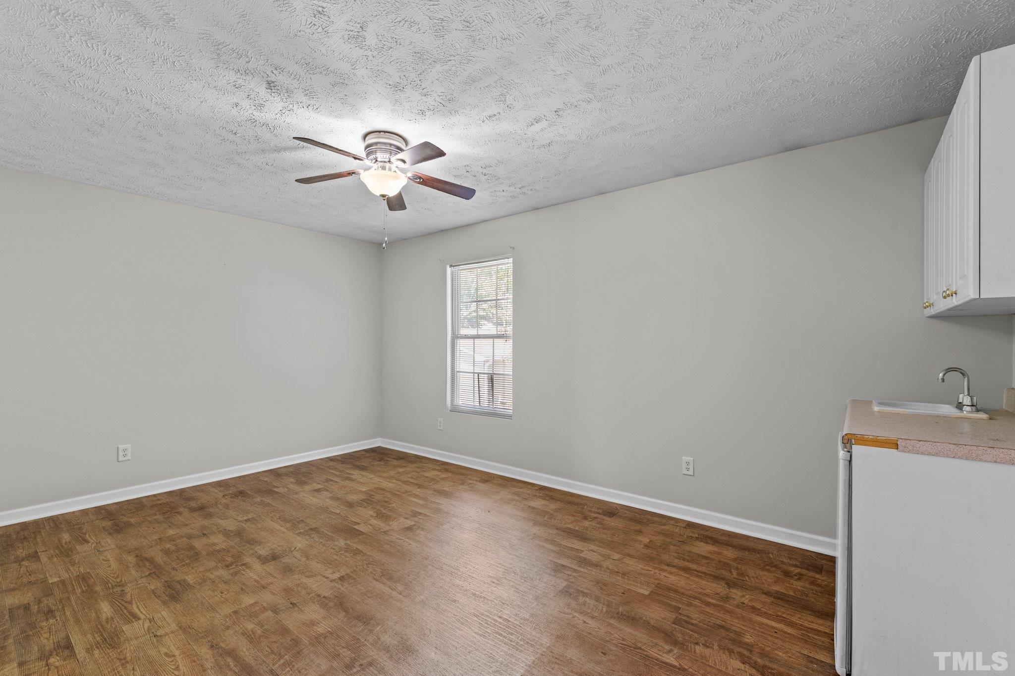 405 Jones Franklin Road Raleigh, NC 27606 - Photo 38 of 41 wooden floor in an empty room with a window