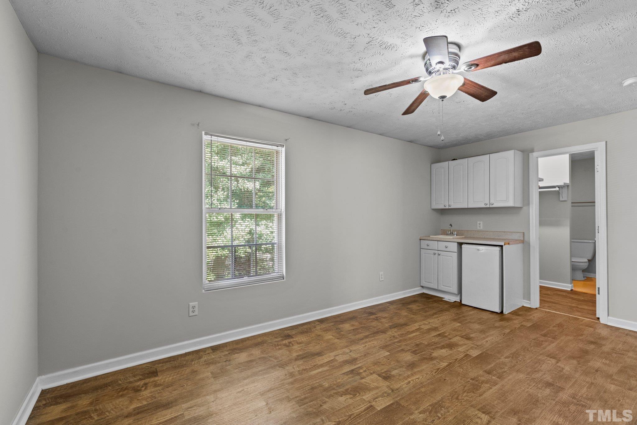 405 Jones Franklin Road Raleigh, NC 27606 - Photo 39 of 41 a view of empty room with wooden floor and window
