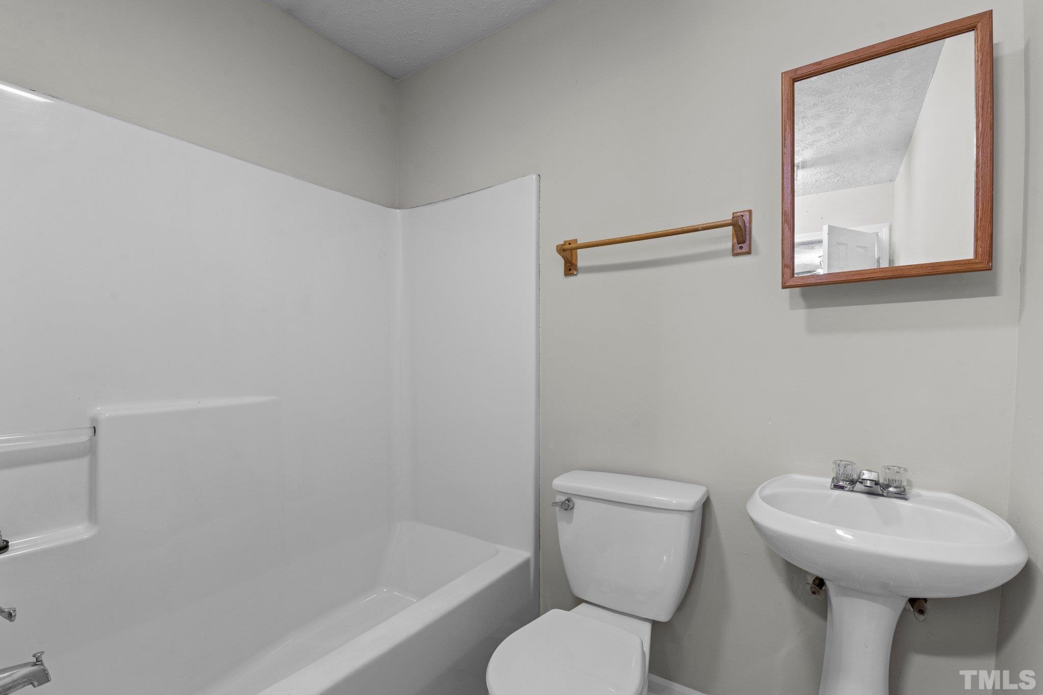 405 Jones Franklin Road Raleigh, NC 27606 - Photo 41 of 41 a bathroom with a sink mirror and toilet