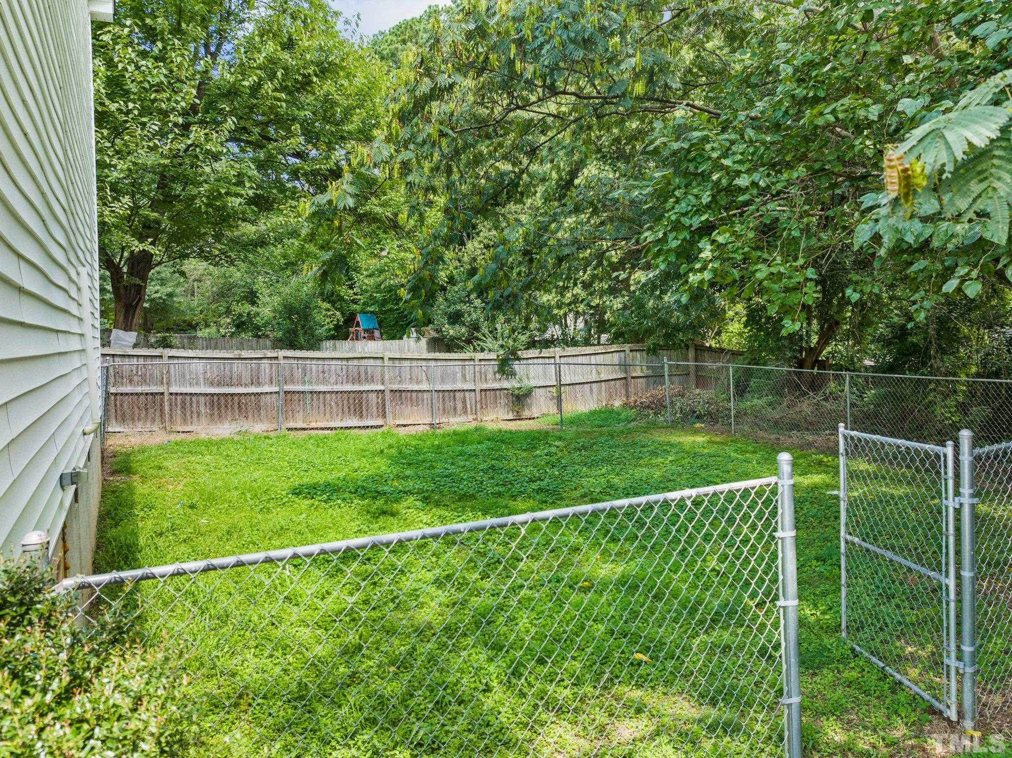 405 Jones Franklin Road Raleigh, NC 27606 - Photo 6 of 41 a view of a yard with a fence