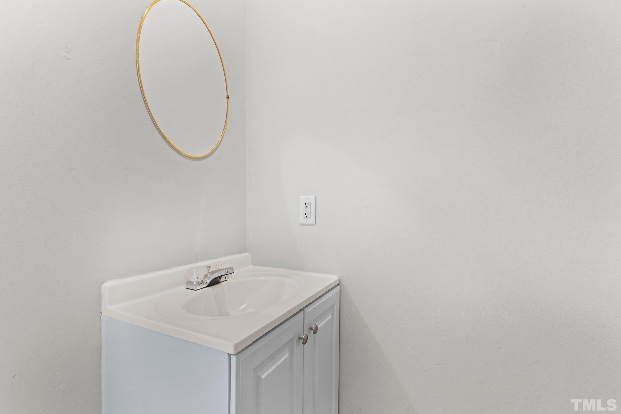 405 Jones Franklin Road Raleigh, NC 27606 - Photo 8 of 41 a bathroom with a sink and a mirror