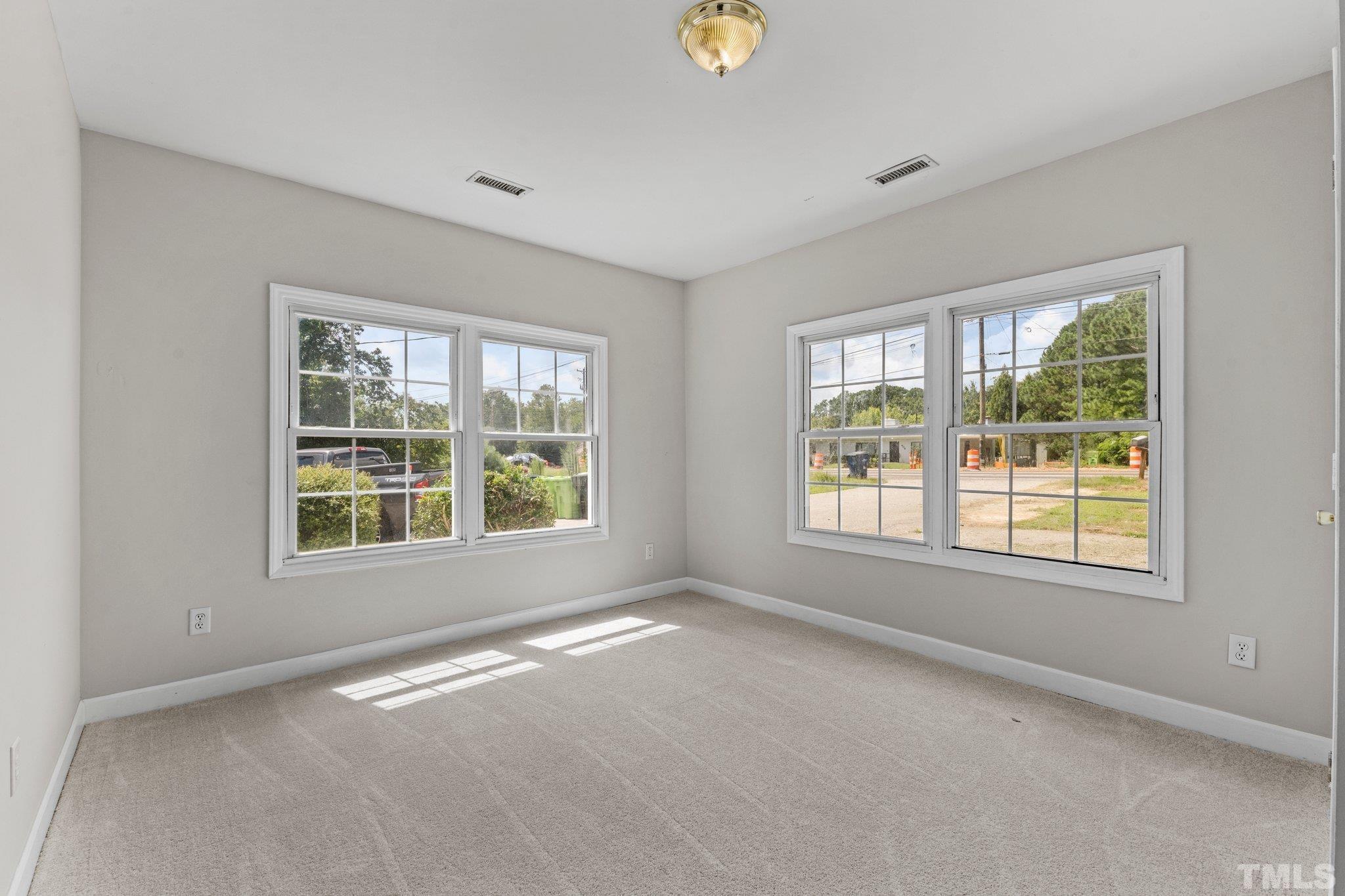 405 Jones Franklin Road Raleigh, NC 27606 - Photo 9 of 41 an empty room with a window