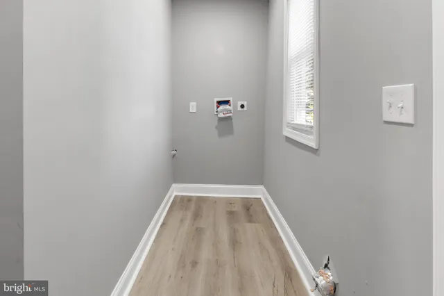 a view of a room with wooden floor and window