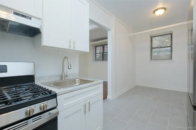 a kitchen with granite countertop a stove and a sink