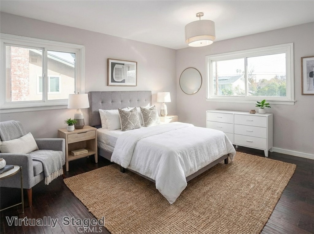 7722 Faust Avenue West Hills, CA 91304 - Photo 11 of 21 The primary suite is awash in natural light and offers sparkling windows, a modern light fixture, dual mirrored-door closets, and wood laminate floors. Virtually staged/enhanced photo