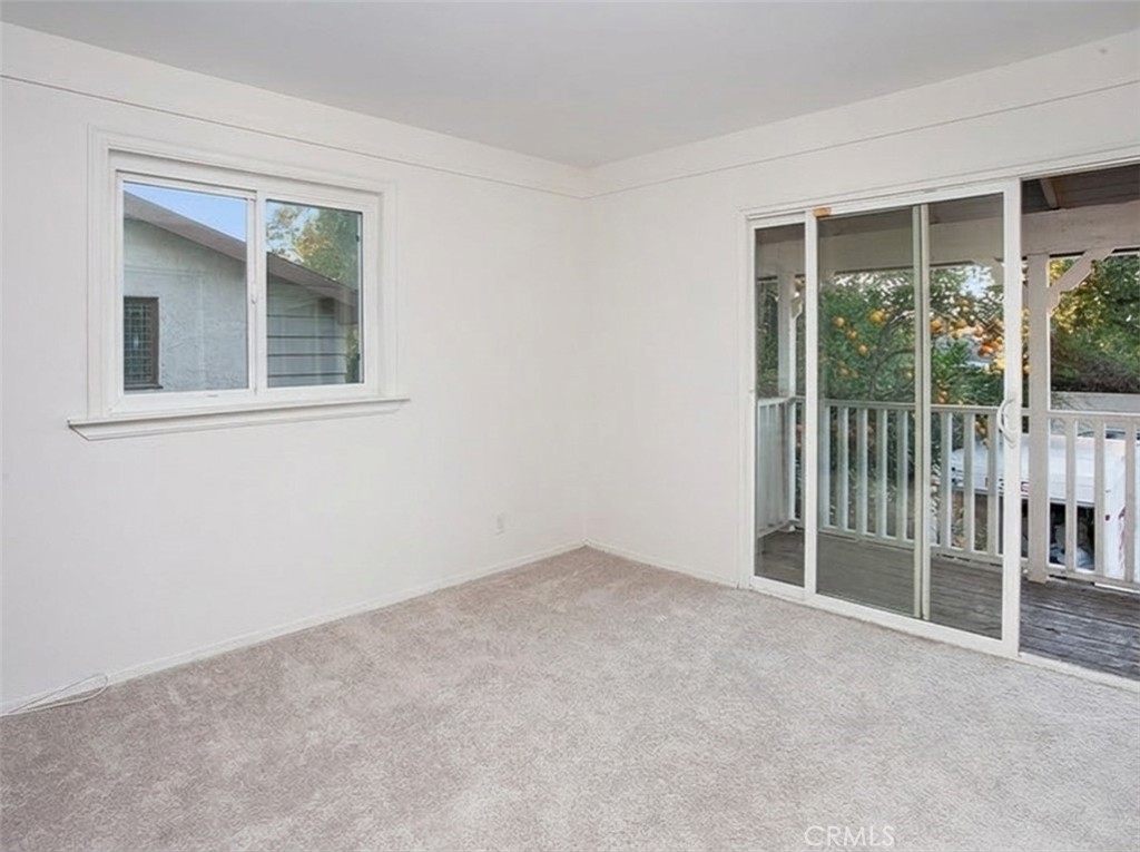 7722 Faust Avenue West Hills, CA 91304 - Photo 18 of 21 Three additional light-filled bedrooms with sparkling windows, ample closet space with mirrored wardrobe doors, and wall-to-wall carpet. One bedroom includes sliding glass doors opening to an expansive covered balcony and can easily function as an office or upstairs den.