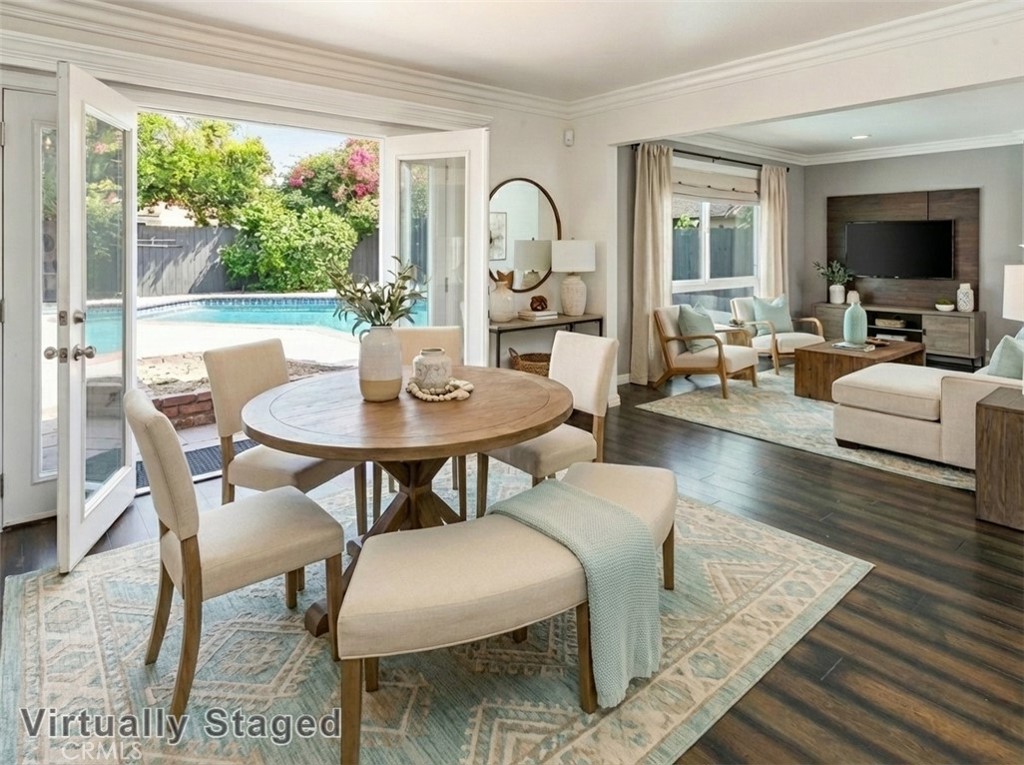 7722 Faust Avenue West Hills, CA 91304 - Photo 9 of 21 The formal dining room adjoins the kitchen and features crown molding, French doors with sidelights that open, and gleaming wood laminate floors, making it ideal for both everyday meals and special gatherings. Virtually staged/enhanced photo