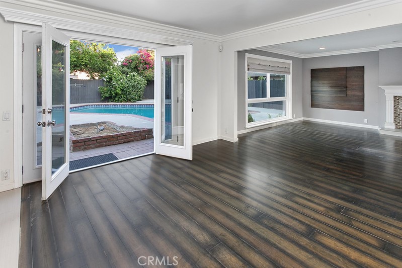 7722 Faust Avenue West Hills, CA 91304 - Photo 10 of 21 The formal dining room adjoins the kitchen and features crown molding, French doors with sidelights that open, and gleaming wood laminate floors, making it ideal for both everyday meals and special gatherings.