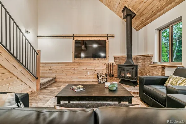 a living room with fireplace furniture and a flat screen tv