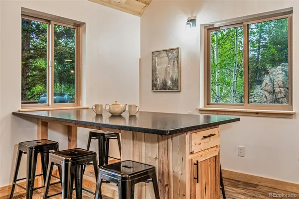 a view of a kitchen area with furniture and large windows
