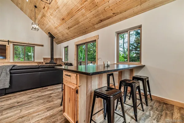 a kitchen with a table chairs stove and sink
