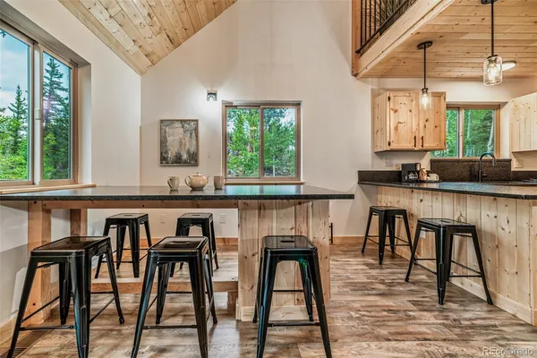 a view of a dining room with furniture and a large window