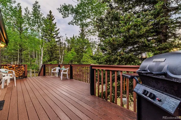 a backyard of a house with wooden floor and outdoor seating