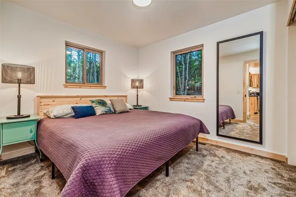 a bedroom with bed and window