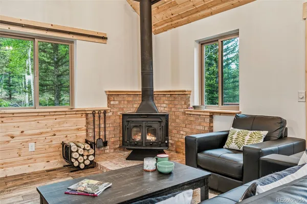 a living room with furniture fireplace and window