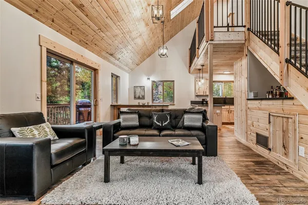 a living room with furniture a fireplace and a table