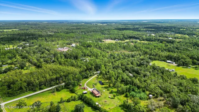 a view of a field with an ocean view