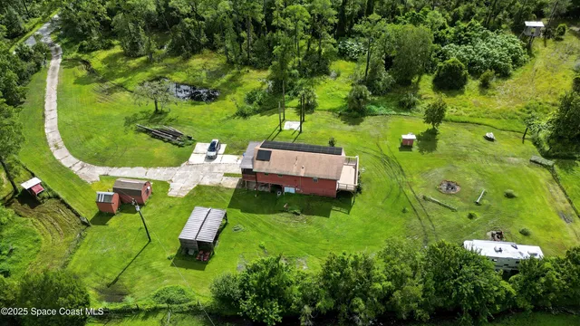 an aerial view of a house with a yard