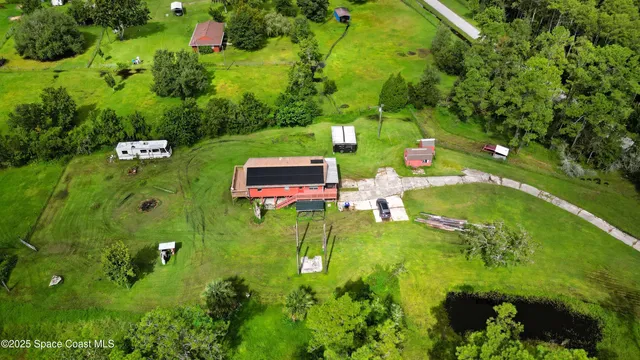 an aerial view of a house with a yard