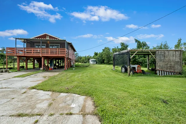 a view of a house with backyard porch and sitting area