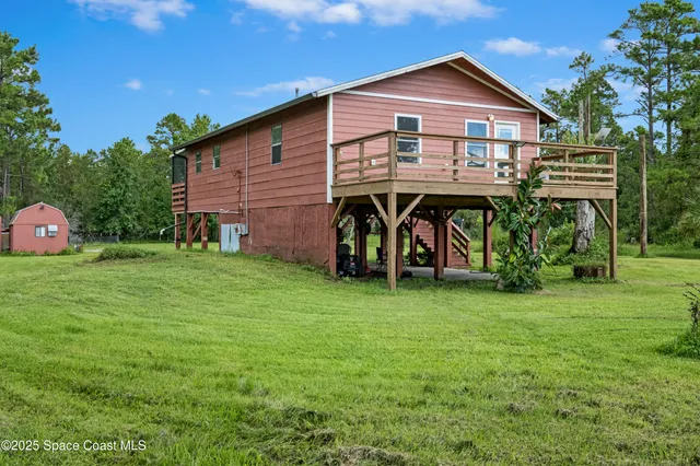 a view of outdoor space with deck and yard