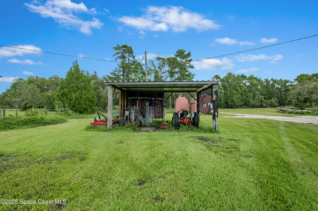 a view of a balcony with wooden floor and iron stairs