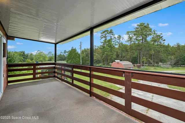 a view of a kitchen with refrigerator and white cabinets