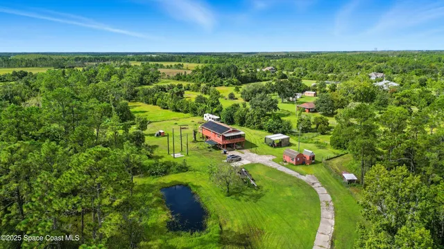 a view of a lush green outdoor space with a lake view