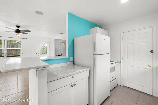 a view of a big room with wooden floor and windows