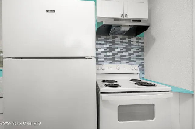 a view of a big room with a ceiling fan and a window