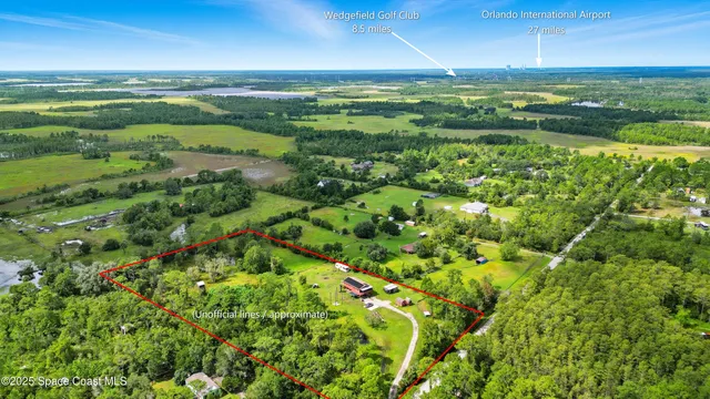 a view of a green field with lots of bushes