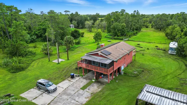 an aerial view of a house with backyard