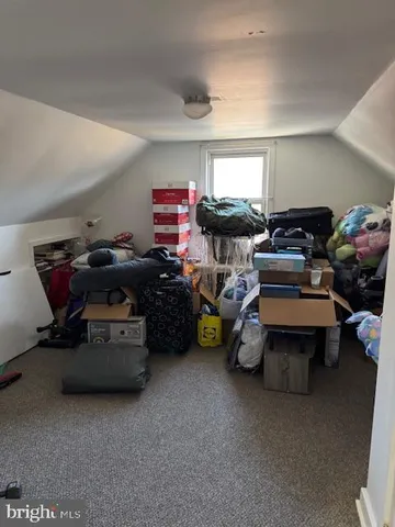 a living room with furniture and a gym machine