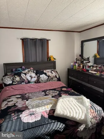 a bed sitting in a bedroom and dresser