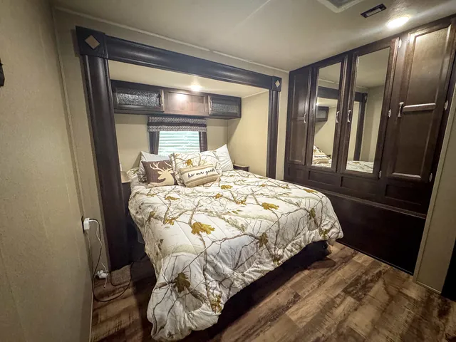 a bed sitting in a bedroom next to a window