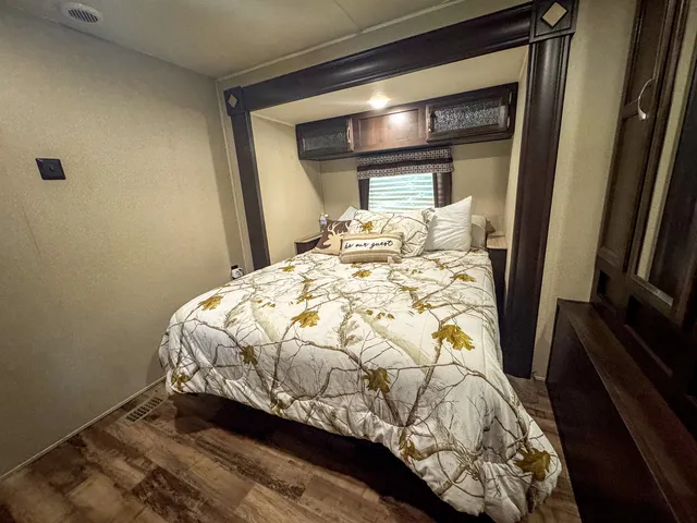 a bed sitting in a bedroom next to a window