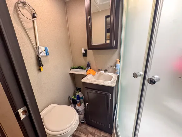 a bathroom with a sink a toilet and shower curtain