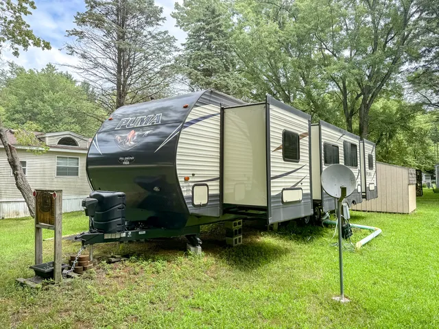 a view of a chair and table in backyard