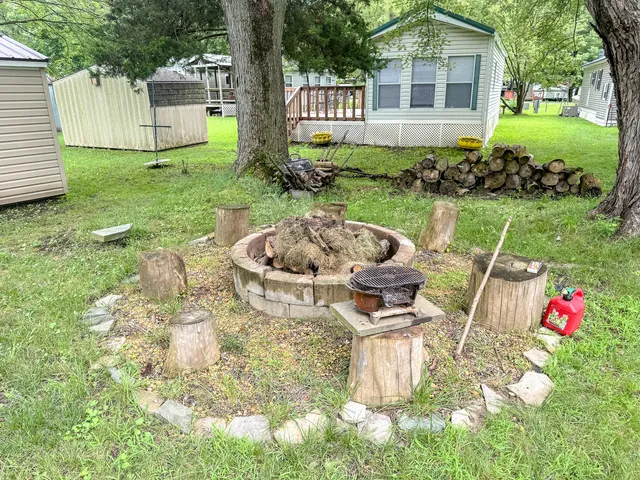a view of a chair and table in backyard of the house