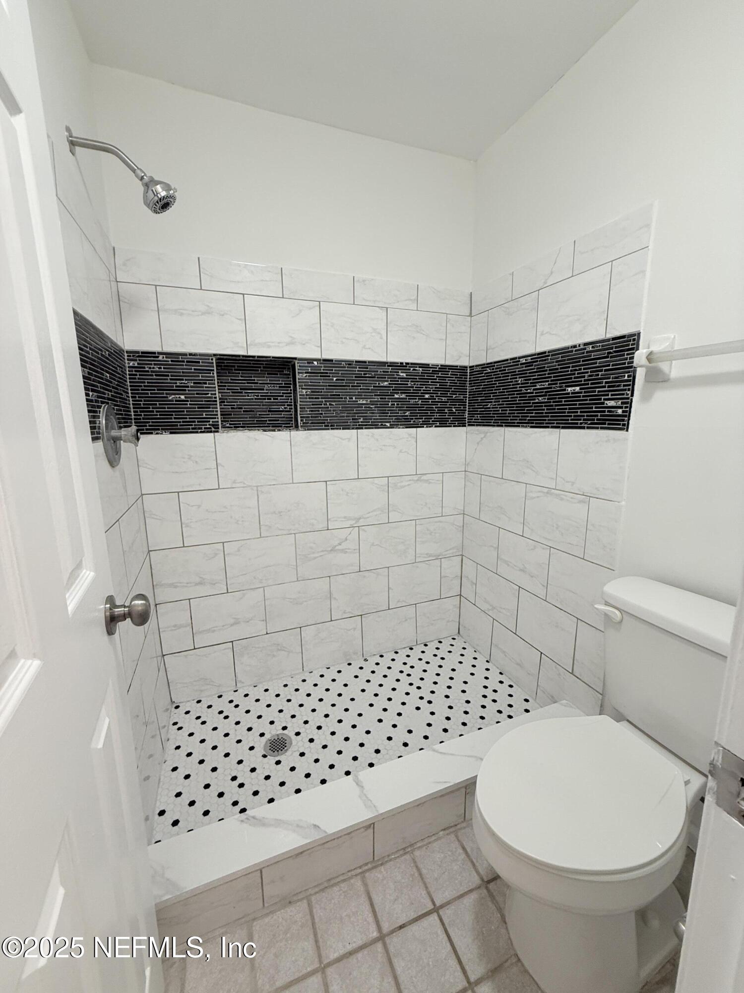 3801 Crown Point Road, Unit 2061 Jacksonville, FL 32257 - Photo 13 of 20 a bathroom with a toilet a window and shower