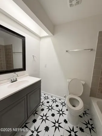 a bathroom with a sink toilet and mirror