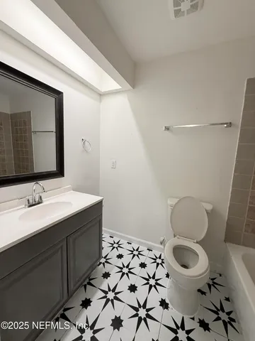 a bathroom with a sink toilet and mirror